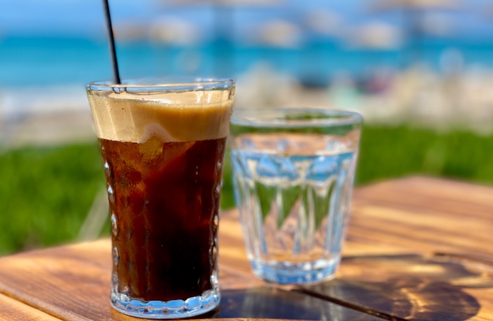 Freddo expresso in glas op terras beach bar Corfu